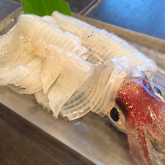 Live-prepared swordtip squid sashimi
