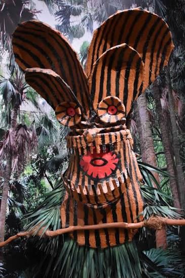 A large-eared Boze mask painted with orange and black stripes