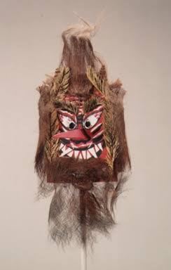 A Toshidon mask with a red face, a wide, split mouth, and straw hair