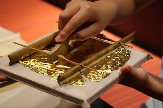 A craftsman beating gold leaf