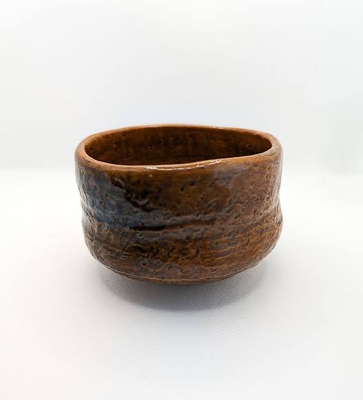 An amber-glazed Ohi ware tea bowl