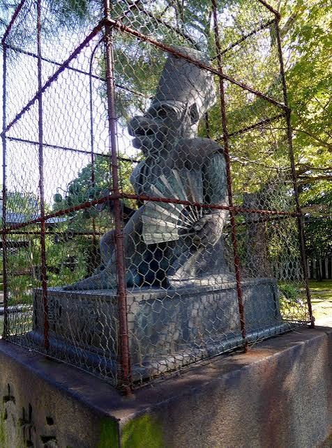 The Sarugatsuji monkey at the palace's north-east corner, caged so it can't slip out at night.
