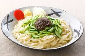 Jajamen topped with meat miso and cucumber