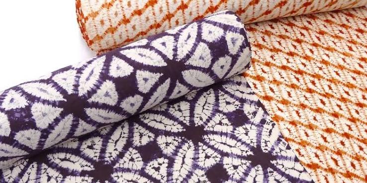 Rolls of purple and madder-red tie-dyed cloth