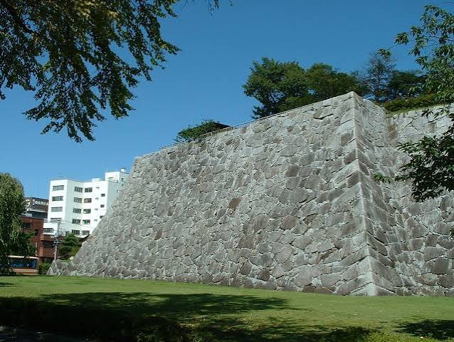 Stone walls and cherry blossoms at Morioka Castle Ruins Park
