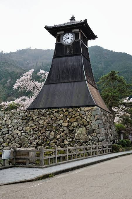 Close-up of Shinkoro tower atop its stone base