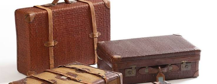 Three vintage suitcases made of woven willow